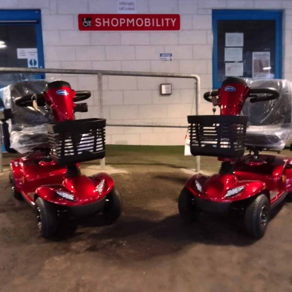 A picture of two mobility scooters on display outside Perth Shopmobility